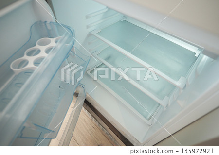 Fridge interior with empty shelves and ice tray Fridge interior with empty shelves and ice tray 135972921
