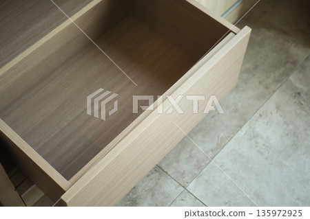 Wooden drawer opens to show empty space inside Wooden drawer opens to show empty space inside 135972925