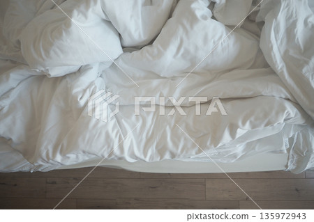 Comfortable bedding on a soft mattress in a bedroom Comfortable bedding on a soft mattress in a bedroom 135972943