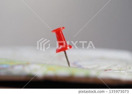 Pin marks location on a map in a simple setting 135973073