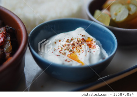 Creamy yogurt dip with spices served on a plate 135973084