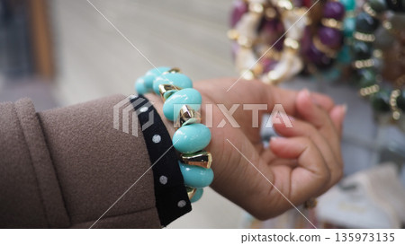Hand with turquoise bracelet in a store display Hand with turquoise bracelet in a store display 135973135