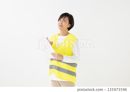 Woman wearing a reflective vest 135973596