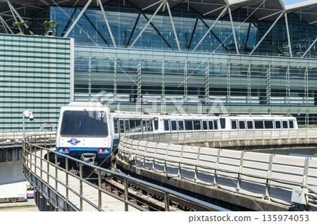 A train on the Wenhu or Brown Line of the Taipei MRT passes by the Taipei Nangang Exhibition Center Hall 2. A train on the Wenhu or Brown Line of the Taipei MRT passes by the Taipei Nangang Exhibition Center Hall 2. 135974053