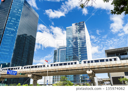 A train on the Wenhu or Brown Line of the Taipei MRT passes by the modern metropolis building in Nangang Software Park Area. A train on the Wenhu or Brown Line of the Taipei MRT passes by the modern metropolis building in Nangang Software Park Area. 135974062