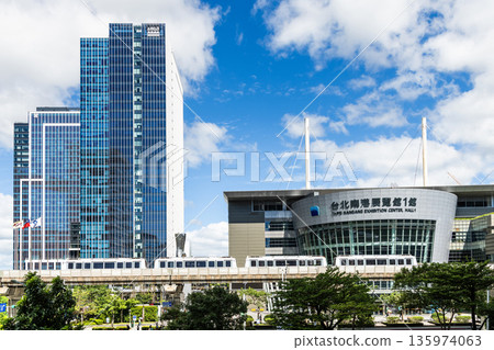 A train on the Wenhu or Brown Line of the Taipei MRT passes by the Taipei Nangang Exhibition Center Hall 1. A train on the Wenhu or Brown Line of the Taipei MRT passes by the Taipei Nangang Exhibition Center Hall 1. 135974063