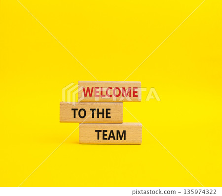 Team symbol. Wooden blocks with words Welcome to the Team. Beautiful yellow background. Business and Welcome to the Team concept. Copy space. 135974322