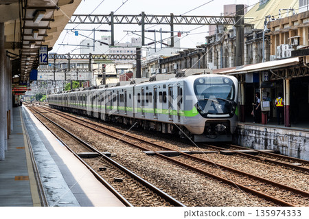 A local train (EMU900 series) is stopped on the platform of the Hsinchu Railway Station. It was the oldest station in Taiwan, now listed as a national monument. A local train (EMU900 series) is stopped on the platform of the Hsinchu Railway Station. It was the oldest station in Taiwan, now listed as a national monument. 135974333