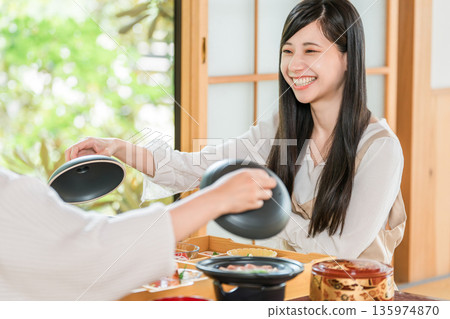 A woman enjoying kaiseki cuisine at a ryokan (room service, kaiseki cuisine, set meal, luxury) A woman enjoying kaiseki cuisine at a ryokan (room service, kaiseki cuisine, set meal, luxury) 135974870
