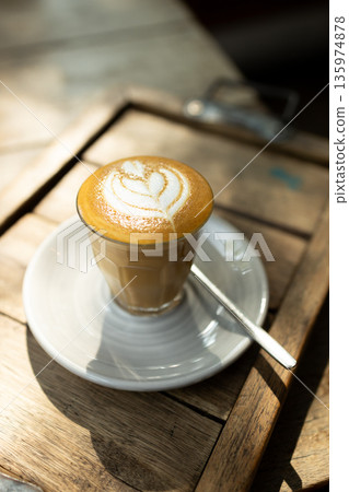 Cup of coffee latte art on wood table. Cup of coffee latte art on wood table. 135974878