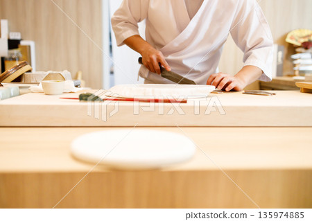 Japanese sushi restaurant with sushi chef background. 135974885