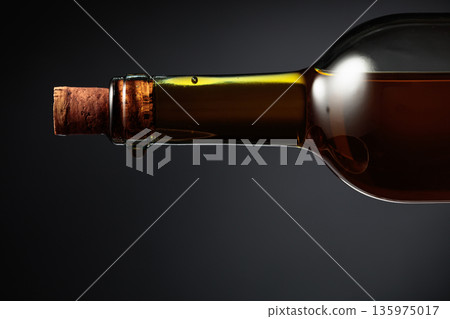 An almost opened bottle of white wine. An almost opened bottle of white wine. 135975017