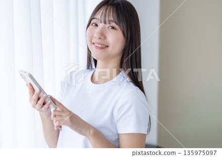 A young woman with a smartphone A young woman with a smartphone 135975097