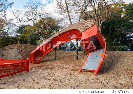 A multi-story playground installed in a park A multi-story playground installed in a park 135975572