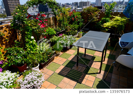Relax and unwind on the roof balcony surrounded by flowers and plants Relax and unwind on the roof balcony surrounded by flowers and plants 135976573