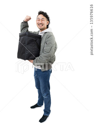 Smiling delivery person holding a delivery bag for food delivery, work image of delivery service Smiling delivery person holding a delivery bag for food delivery, work image of delivery service 135976616