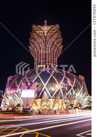 Beautiful night view of the Grand Lisboa building, the most famous, richest casino, and a luxury hotel resort stands in Macau. Beautiful night view of the Grand Lisboa building, the most famous, richest casino, and a luxury hotel resort stands in Macau. 135976849