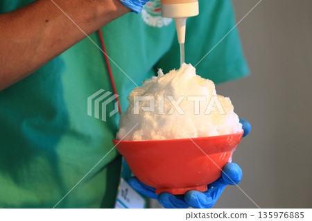 Large serving of shaved ice Shaved ice with plenty of syrup Large serving of shaved ice Shaved ice with plenty of syrup 135976885