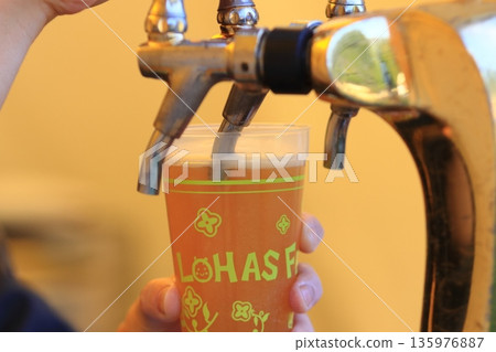 Beer poured from the tap, craft beer, draft beer 135976887