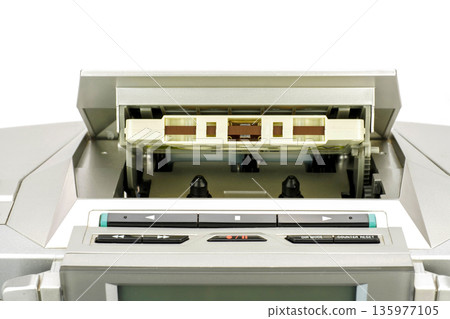 A cassette tape placed in a radio cassette player 135977105