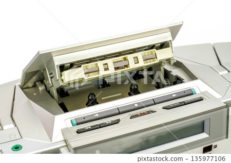 A cassette tape placed in a radio cassette player A cassette tape placed in a radio cassette player 135977106