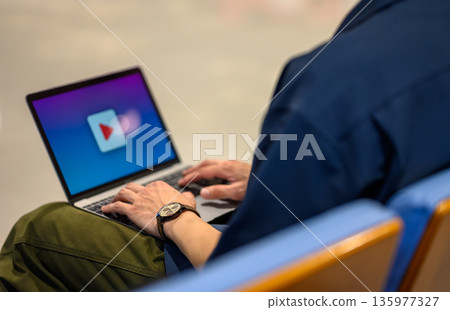 Watching a video on a laptop ■Filming cooperation: Kansai International Airport (KIX) Watching a video on a laptop ■Filming cooperation: Kansai International Airport (KIX) 135977327