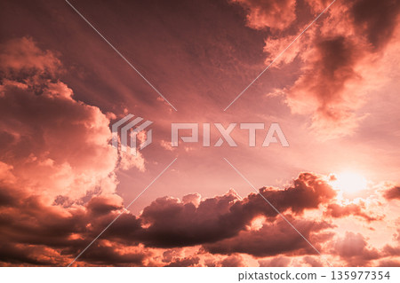 Dramatic Pink Clouds and Sun in Colorful Evening Sky Dramatic Pink Clouds and Sun in Colorful Evening Sky 135977354