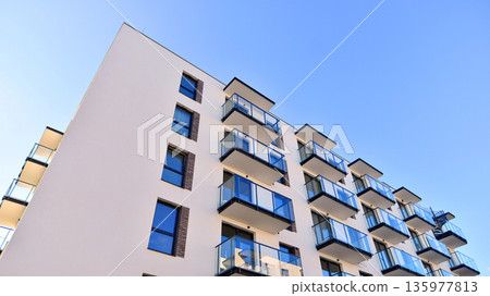 Apartment residential house and home facade architecture and outdoor facilities. Blue sky on the background. Sunlight in sunrise. Apartment residential house and home facade architecture and outdoor facilities. Blue sky on the background. Sunlight in sunrise. 135977813