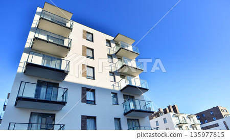 Apartment residential house and home facade architecture and outdoor facilities. Blue sky on the background. Sunlight in sunrise. Apartment residential house and home facade architecture and outdoor facilities. Blue sky on the background. Sunlight in sunrise. 135977815