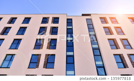Apartment residential house and home facade architecture and outdoor facilities. Blue sky on the background. Sunlight in sunrise. Apartment residential house and home facade architecture and outdoor facilities. Blue sky on the background. Sunlight in sunrise. 135977818