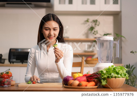 Fit woman enjoys healthy fruit breakfast after yoga training. fitness, nutrition, home lifestyle. 135977976