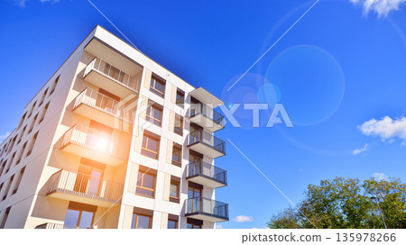 Apartment residential house and home facade architecture and outdoor facilities. Blue sky on the background. Sunlight in sunrise. Apartment residential house and home facade architecture and outdoor facilities. Blue sky on the background. Sunlight in sunrise. 135978266