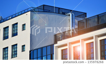 Apartment residential house and home facade architecture and outdoor facilities. Blue sky on the background. Sunlight in sunrise. Apartment residential house and home facade architecture and outdoor facilities. Blue sky on the background. Sunlight in sunrise. 135978268