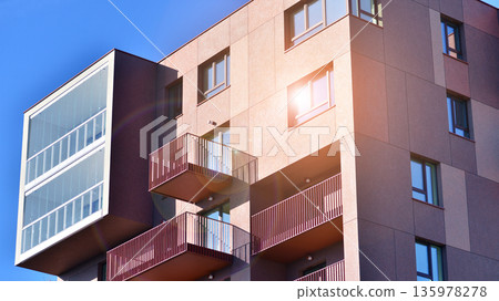 Apartment residential house and home facade architecture and outdoor facilities. Blue sky on the background. Sunlight in sunrise. Apartment residential house and home facade architecture and outdoor facilities. Blue sky on the background. Sunlight in sunrise. 135978278