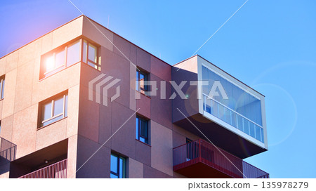 Apartment residential house and home facade architecture and outdoor facilities. Blue sky on the background. Sunlight in sunrise. Apartment residential house and home facade architecture and outdoor facilities. Blue sky on the background. Sunlight in sunrise. 135978279