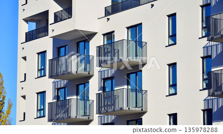 Apartment residential house and home facade architecture and outdoor facilities. Blue sky on the background. Sunlight in sunrise. Apartment residential house and home facade architecture and outdoor facilities. Blue sky on the background. Sunlight in sunrise. 135978288