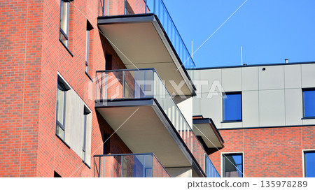 Apartment residential house and home facade architecture and outdoor facilities. Blue sky on the background. Sunlight in sunrise. Apartment residential house and home facade architecture and outdoor facilities. Blue sky on the background. Sunlight in sunrise. 135978289
