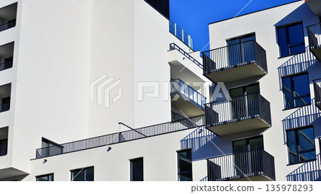 Apartment residential house and home facade architecture and outdoor facilities. Blue sky on the background. Sunlight in sunrise. Apartment residential house and home facade architecture and outdoor facilities. Blue sky on the background. Sunlight in sunrise. 135978293