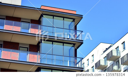 Apartment residential house and home facade architecture and outdoor facilities. Blue sky on the background. Sunlight in sunrise. Apartment residential house and home facade architecture and outdoor facilities. Blue sky on the background. Sunlight in sunrise. 135978314