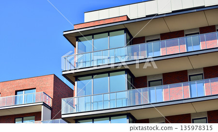 Apartment residential house and home facade architecture and outdoor facilities. Blue sky on the background. Sunlight in sunrise. Apartment residential house and home facade architecture and outdoor facilities. Blue sky on the background. Sunlight in sunrise. 135978315