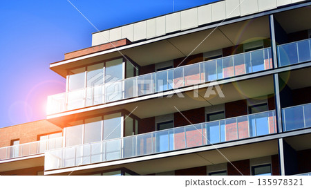 Apartment residential house and home facade architecture and outdoor facilities. Blue sky on the background. Sunlight in sunrise. Apartment residential house and home facade architecture and outdoor facilities. Blue sky on the background. Sunlight in sunrise. 135978321