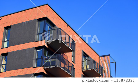 Apartment residential house and home facade architecture and outdoor facilities. Blue sky on the background. Sunlight in sunrise. Apartment residential house and home facade architecture and outdoor facilities. Blue sky on the background. Sunlight in sunrise. 135978355