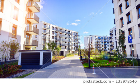 Apartment residential house and home facade architecture and outdoor facilities. Blue sky on the background. Sunlight in sunrise. Apartment residential house and home facade architecture and outdoor facilities. Blue sky on the background. Sunlight in sunrise. 135978540