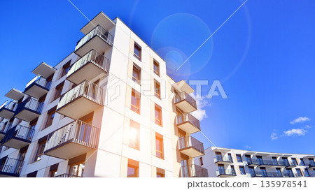 Apartment residential house and home facade architecture and outdoor facilities. Blue sky on the background. Sunlight in sunrise. Apartment residential house and home facade architecture and outdoor facilities. Blue sky on the background. Sunlight in sunrise. 135978541