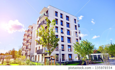 Apartment residential house and home facade architecture and outdoor facilities. Blue sky on the background. Sunlight in sunrise. Apartment residential house and home facade architecture and outdoor facilities. Blue sky on the background. Sunlight in sunrise. 135978554