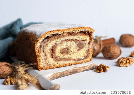 Homemade strudel with walnuts isolated on white Homemade strudel with walnuts isolated on white 135978638