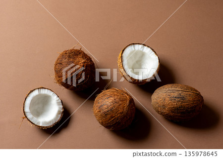 Coconut fruit on a brown background Coconut fruit on a brown background 135978645