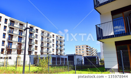 Luxury house complex of flats in condo area. Part of city real estate property, condo architecture on a sunny day no people. 135978944