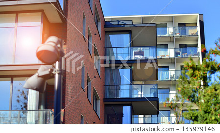 Luxury house complex of flats in condo area. Part of city real estate property, condo architecture on a sunny day no people. Luxury house complex of flats in condo area. Part of city real estate property, condo architecture on a sunny day no people. 135979146