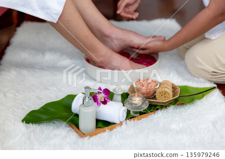 Man indulges in blissful foot massage at luxurious spa salon. Quiescent 135979246